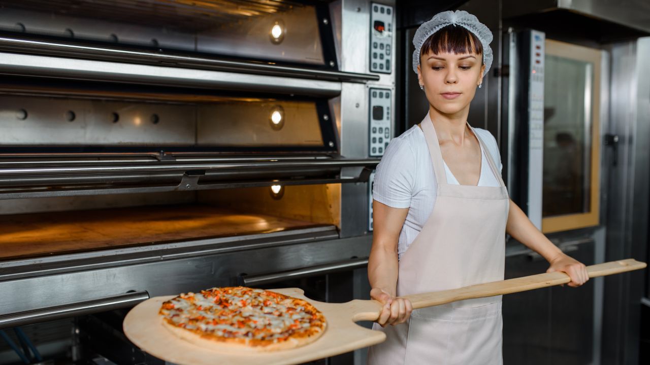 putting the pizza in the oven