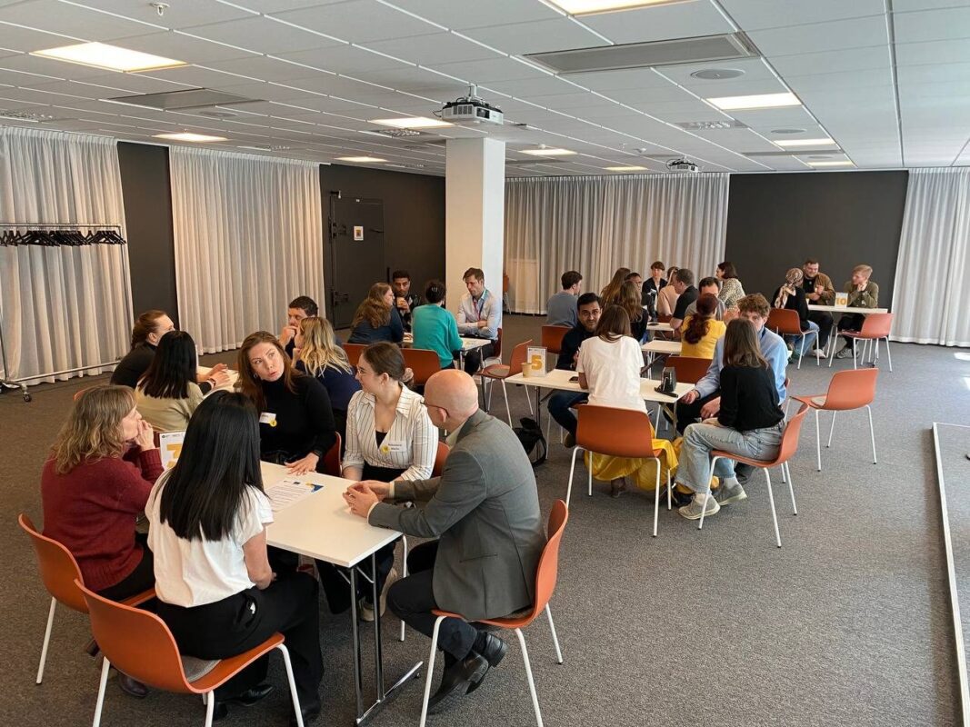 Jobseekers and employers talking at tables during a recruitment event